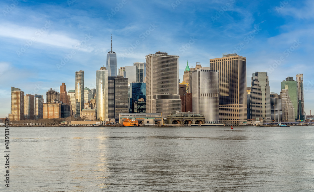 Fototapeta premium View of lower Manhattan with skyscrapers blue cloudy sky