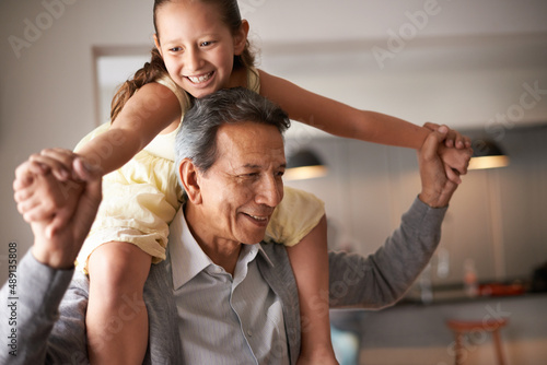 Grandpa is so fun. Shot of a grandfather giving his little granddaughter a piggy back.