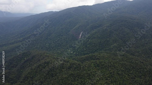 Distance View Of Windin Falls In Tropical Mountain Forest Near Wooroonooran, Queensland, Australia. Aerial Wide Shot photo