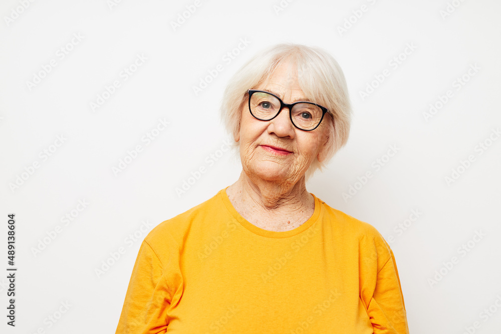 Photo of retired old lady vision problems with glasses light background Photo of retired old lady vision problems with glasses light background