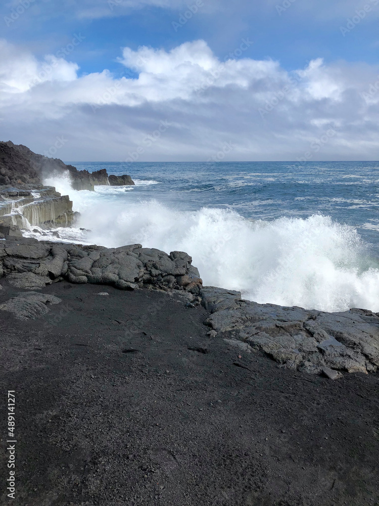 waves crash against rocky coast