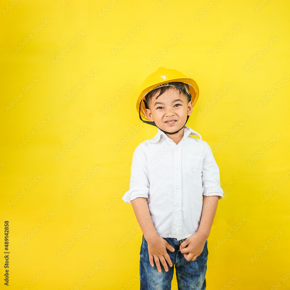 A kid wearing an engineer uniform portraying as a professional contractor. Act like a builder and real estate engineer.