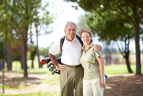 Golf - A sport that brings us closer together. Portrait of a mature and happy couple embracing during a game of golf. © Thomas Talkner/peopleimages.com