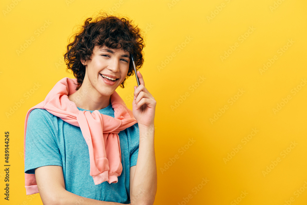 curly guy thinks with a pen in his hands isolated backgrounds