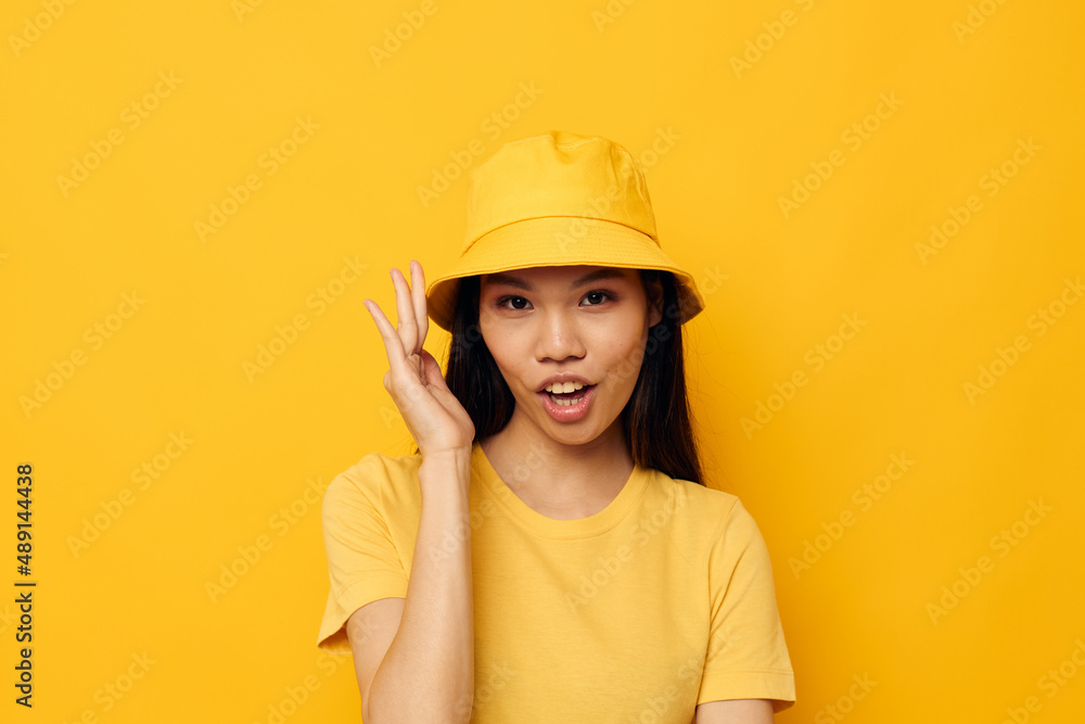 pretty brunette wearing a yellow hat posing emotions studio model unaltered