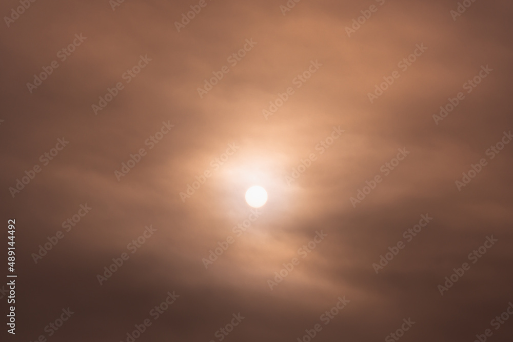 The sun behind the smoke. City smog.