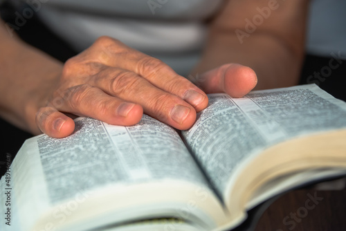 A woman is engaged in reading spiritual books.