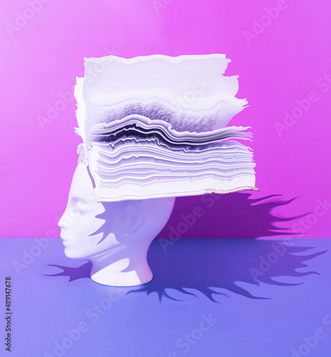 Human head with open book on blue and purple background. Surreal, education, study and knowledge concept