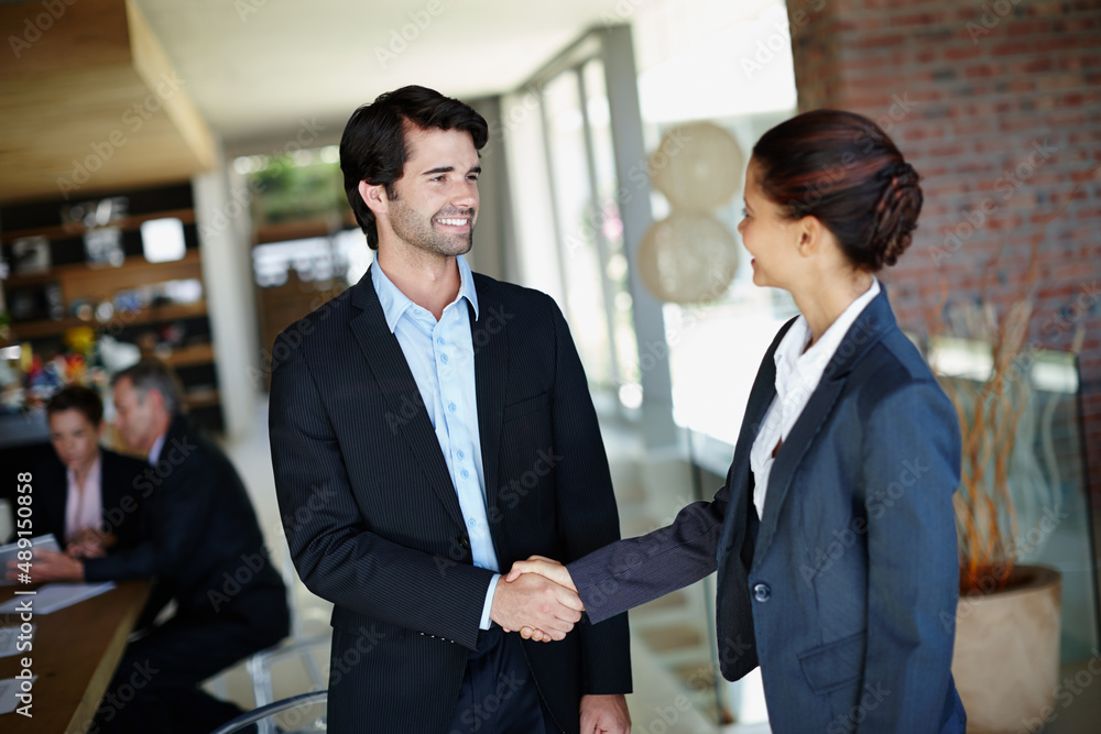 Its good to finally meet you. A smiling businessman shaking hands with a client. Its good to finally meet you. A smiling businessman shaking hands with a client.