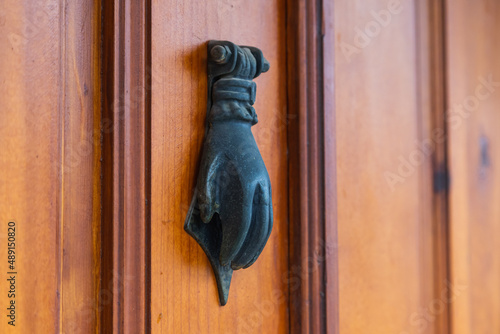 old-fashioned metal handle.Doorknocker on allwood door. photo