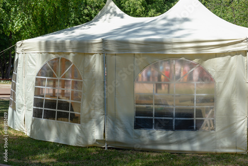 White fabric tent in the park in summer.