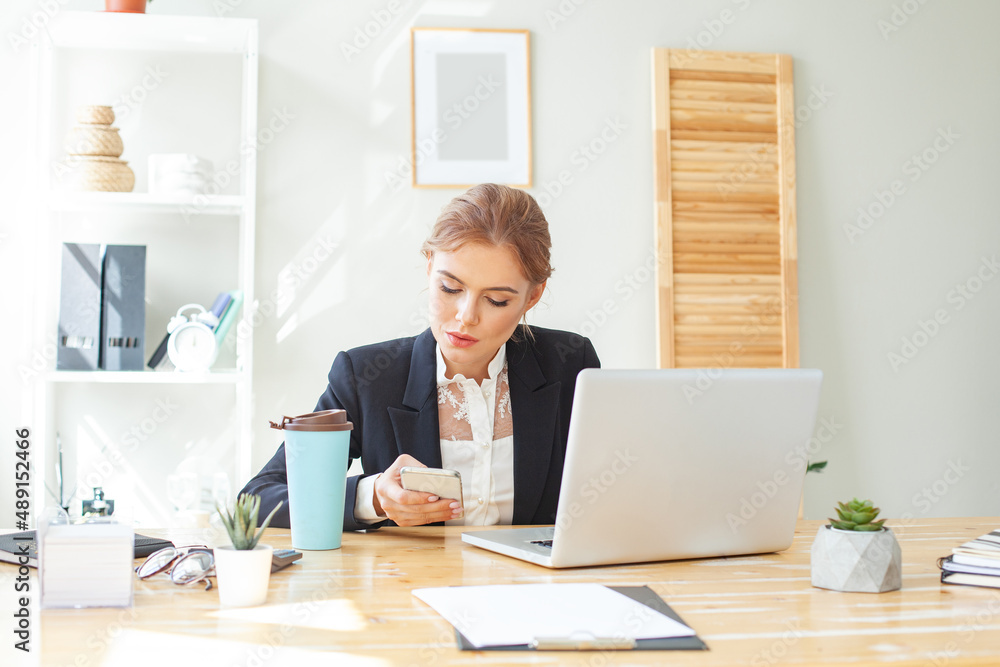 Young businesswoman with computer in office Young businesswoman with computer in office