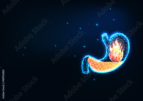 Futuristic acid reflux, pyrosis or heartburn concept with glowing low polygonal stomach and fire 