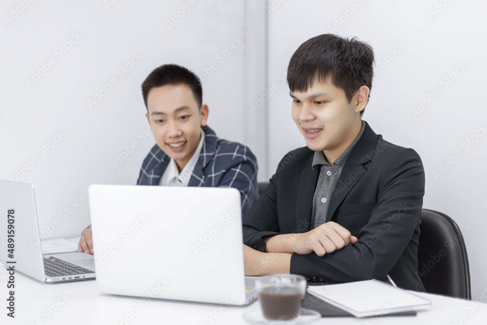 Business partners concept a young businessman talking to his colleague about a marketing plan of the new upcoming product Business partners concept a young businessman talking to his colleague about a marketing plan of the new upcoming product
