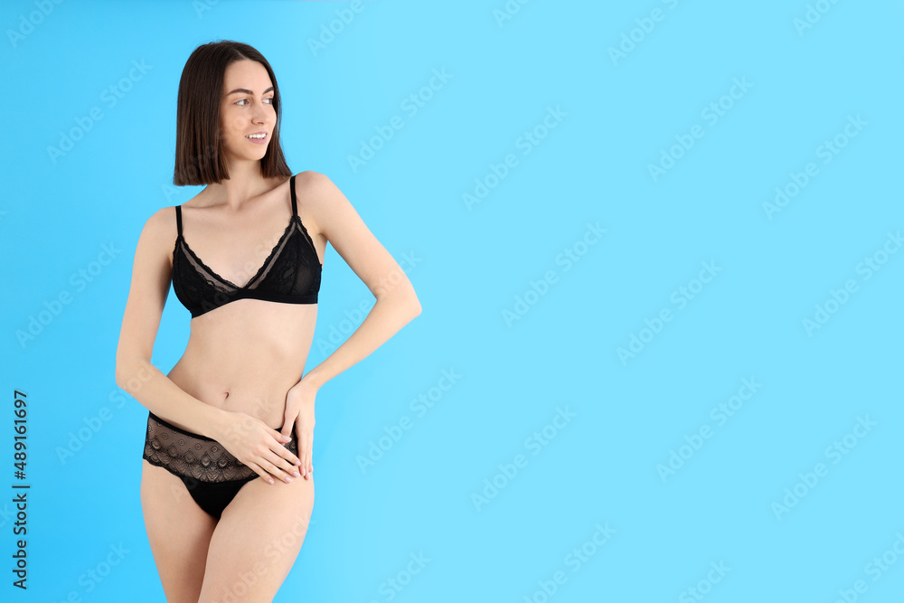 Concept of underwear with young woman on blue background Concept of underwear with young woman on blue background