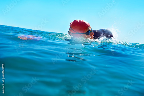 Training wherever theres water. Shot of a swimmer in the open ocean.