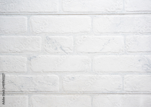 The modern texture of a white brick wall can be used as a background or a sample for a design.