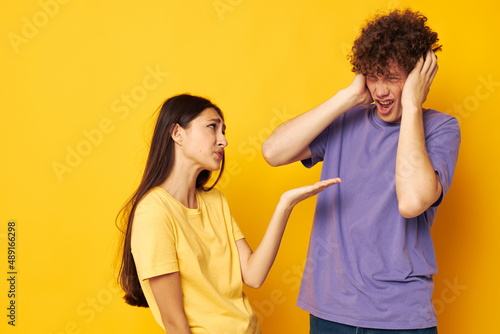 portrait of a man and a woman Friendship posing fun studio yellow background unaltered