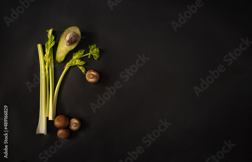 Green healthy vegetables and fruits on a black background. Green products on a dark background. 