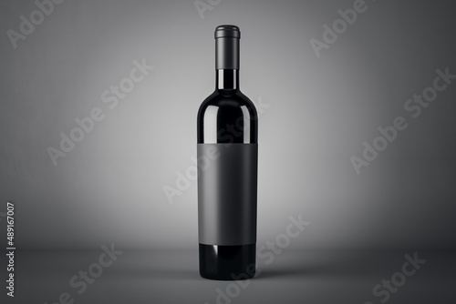 Black wine bottle with empty blank label with copyspace for your logo on abstract dark background, red wine concept. 3D rendering, mockup © Who is Danny