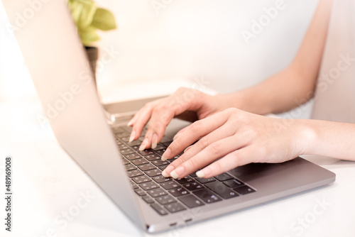 hands typing on laptop