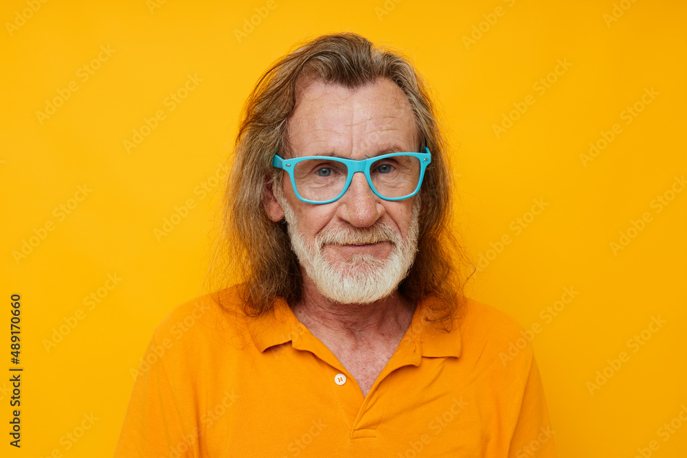 elderly man gray beard communication on the phone emotions yellow background