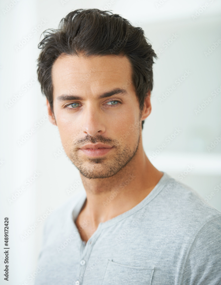 Hes a man of magnificence. Head and shoulder shot of a handsome young man looking away. Hes a man of magnificence. Head and shoulder shot of a handsome young man looking away.
