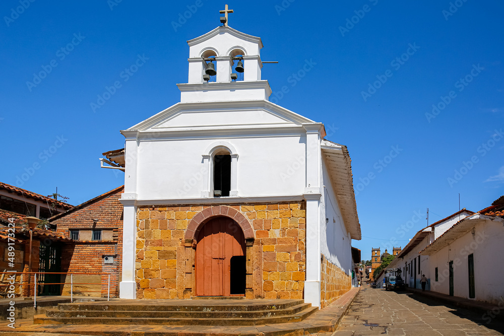 Historical chapel in center of Barichara with white plaster and masonry on a sunny day, Colombia