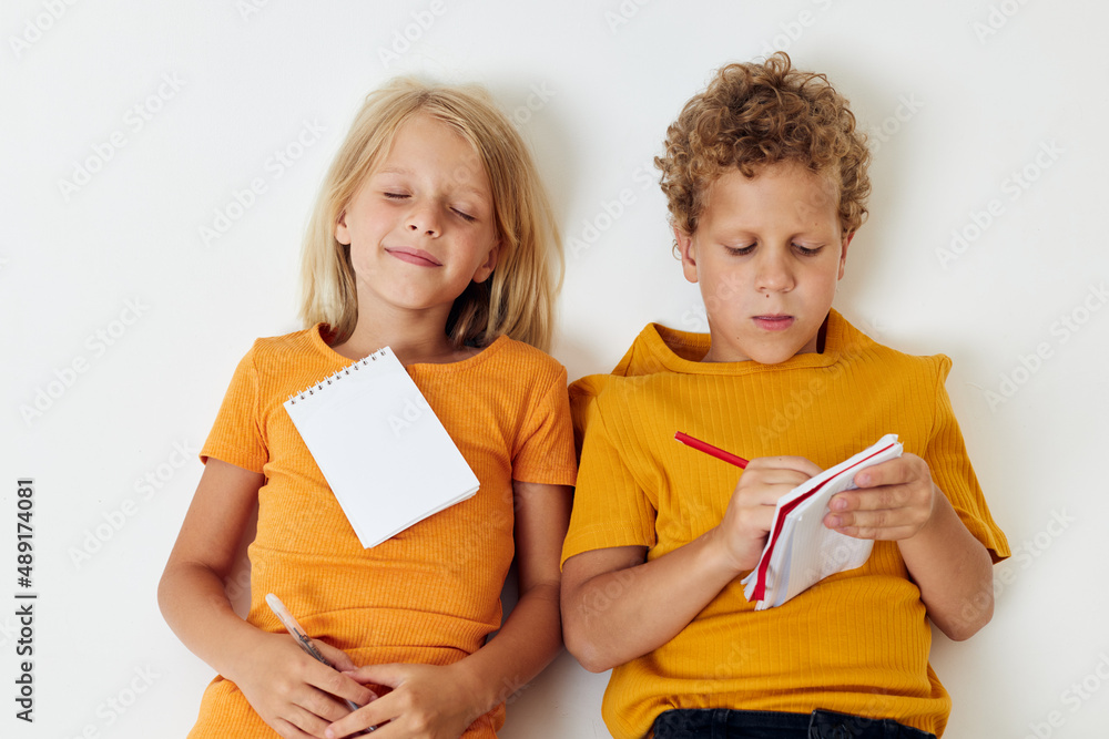 Small children drawing fun games with notepad isolated background unaltered Small children drawing fun games with notepad isolated background unaltered