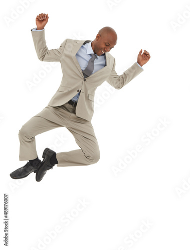 Floating on success. An African-American businessman jumping joyfully in the air.