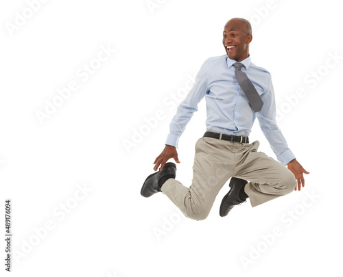Hes on top of the world. An African-American businessman jumping in the air.