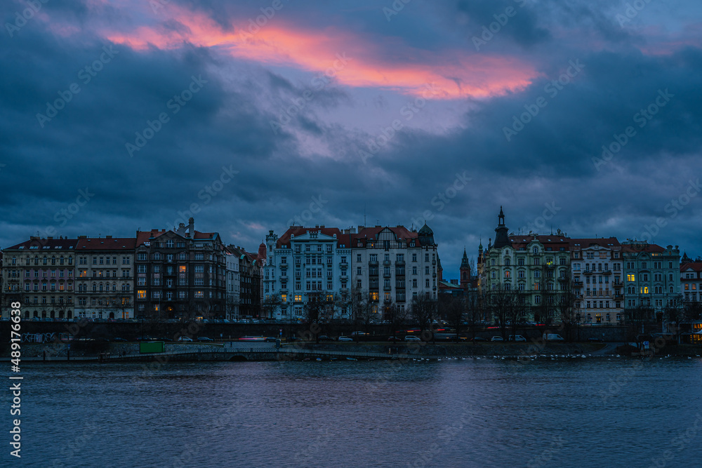 Dreamy Prague panorama with Vltava river at sunset with beautifully painted pink sky, Czech Republic.