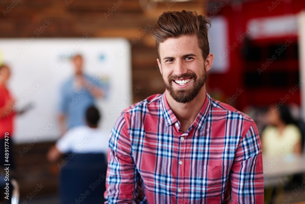 Hes the office go-getter. Portrait of a young male designer in a casual work environment. Hes the office go-getter. Portrait of a young male designer in a casual work environment.