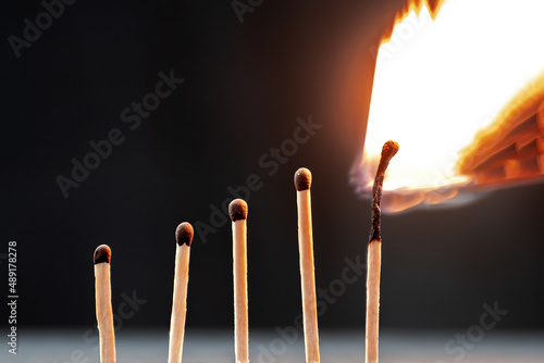 Five matches on a black background. Growth chart of an employee at work before emotional or physical burnout.