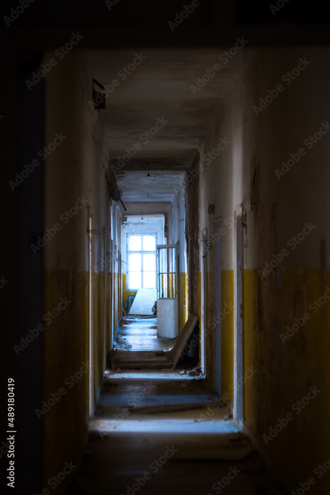 Light at the end of tunnel - long dark corridor of abandoned military barracks Light at the end of tunnel - long dark corridor of abandoned military barracks