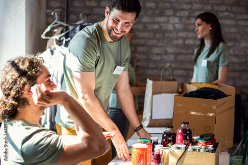 Group of volunteers working in community charity donation center.