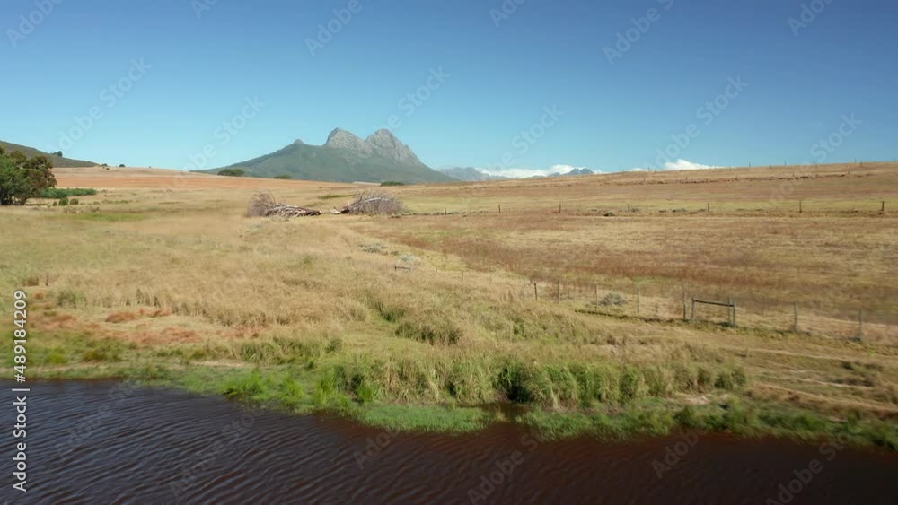 Stunning Scenery Over Savannah With View Of Simonsberg Nature Reserve In Stellenbosch, South Africa. low aerial Stunning Scenery Over Savannah With View Of Simonsberg Nature Reserve In Stellenbosch, South Africa. low aerial