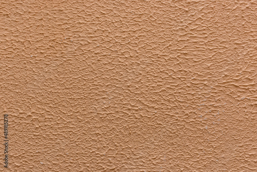 Brown coffee color plaster wall abstract pattern coarse surface rough texture stucco background