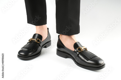 Loafers isolated on white background. Pair of Stylish Expensive Modern Leather Black Loafers Shoes. Fashion concept with woman shoes on white.