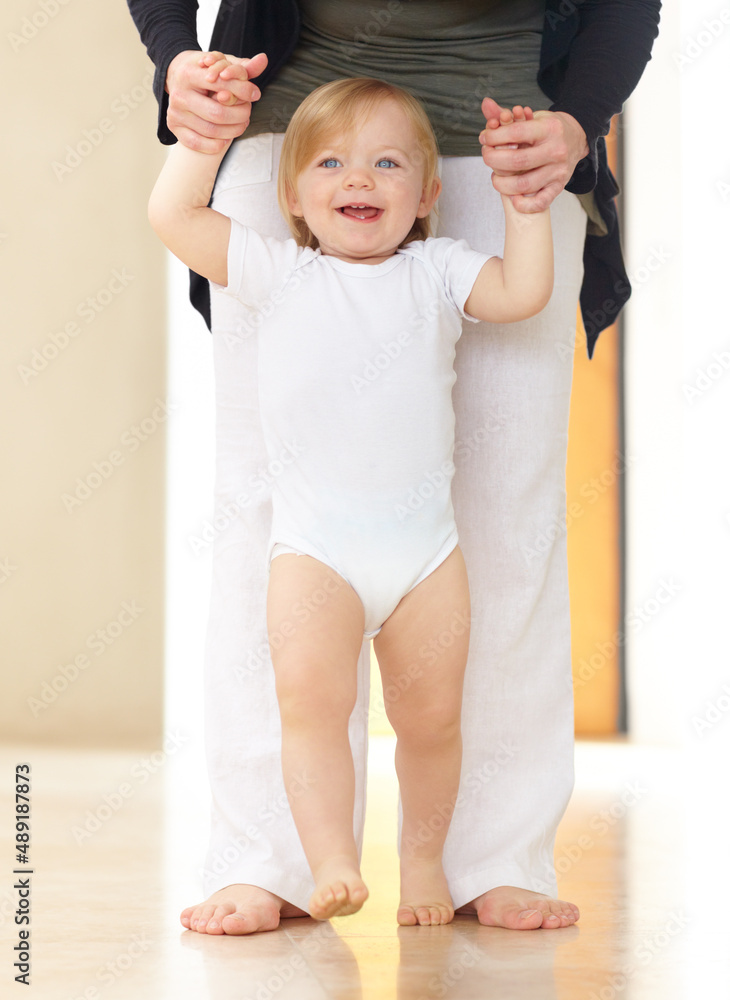 Magic moment. A cute baby learning to walk.