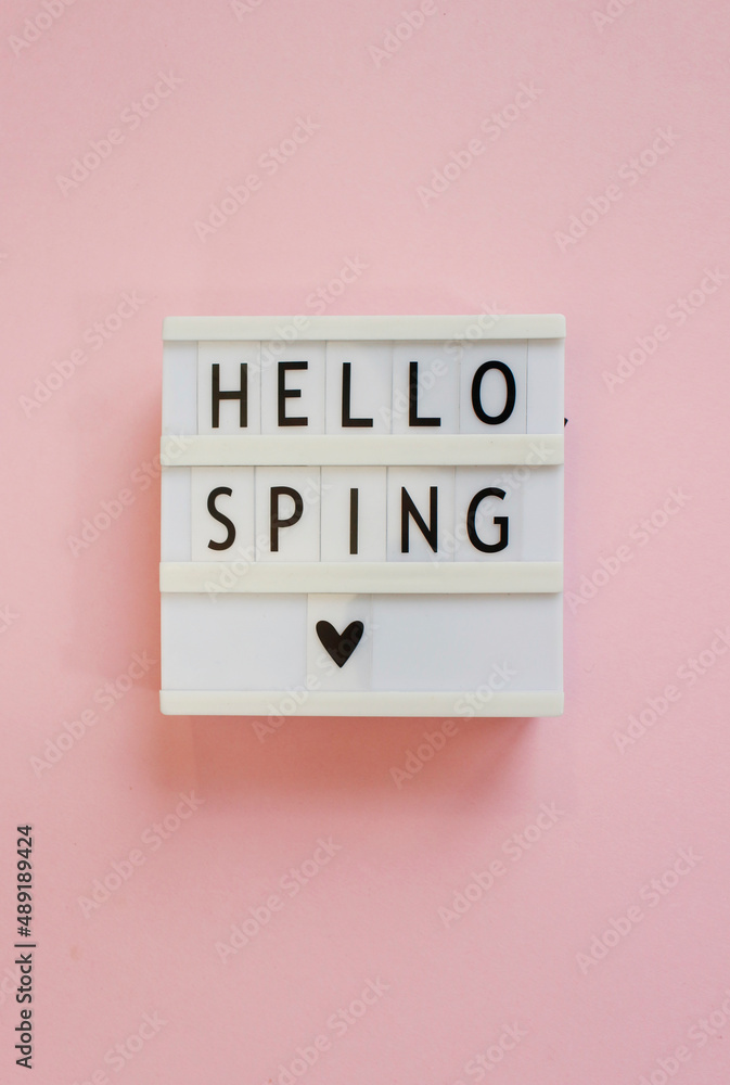 lightbox with text Hello spring on pink background. Top view Flat lay Springtime concept lightbox with text Hello spring on pink background. Top view Flat lay Springtime concept