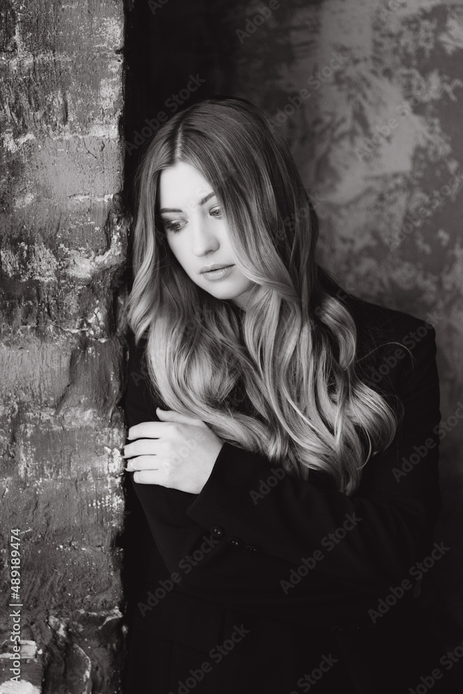 Fototapeta premium Beautiful girl, blonde, in a black suit, office style, work clothes, no war, Ukraine