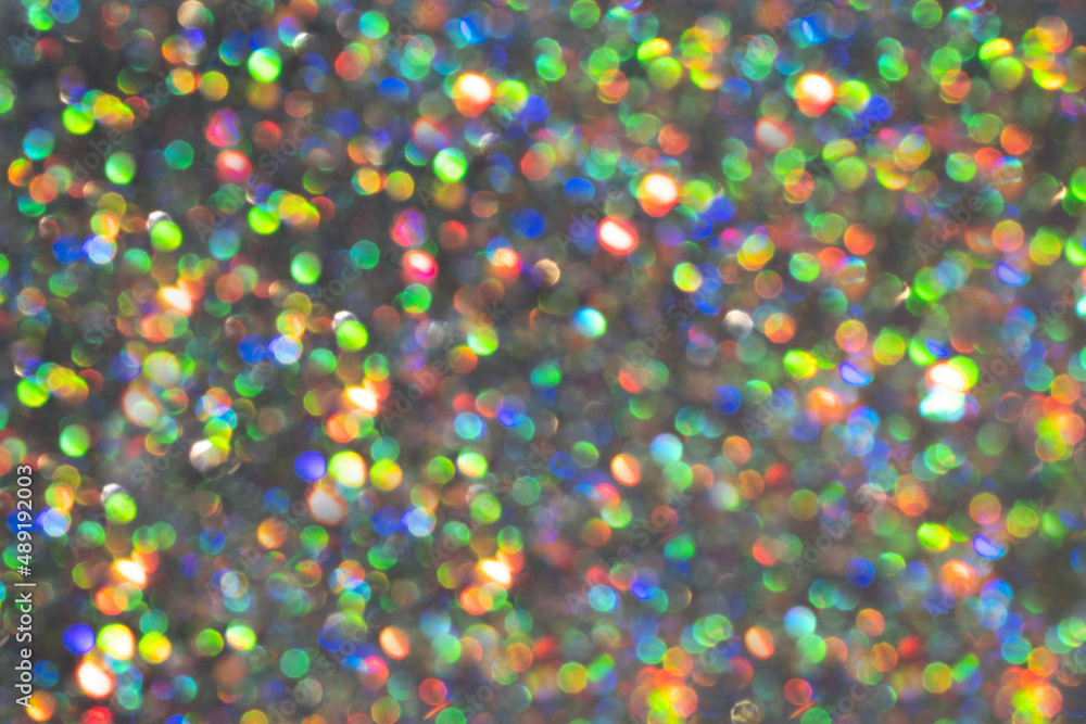 A rainbow sparkle background with colourful bokeh