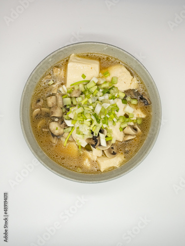 A bowl of shallot, tofu and mushroom soup