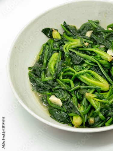 A plate of garlic fried spinach,