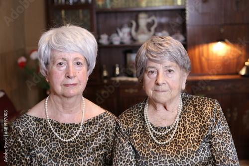Fraternal twins wearing animal print matching outfits