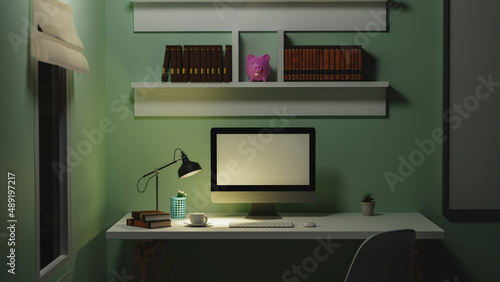 Office at night, dark work space, blank screen desktop computer mock up on white desk with light from table lamp, decor and blurred office interior in background, 3d rendering © Songsak C