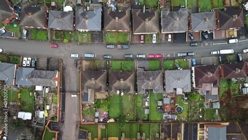 Dull aerial top down view of a British council estate of low cost homes and gardens