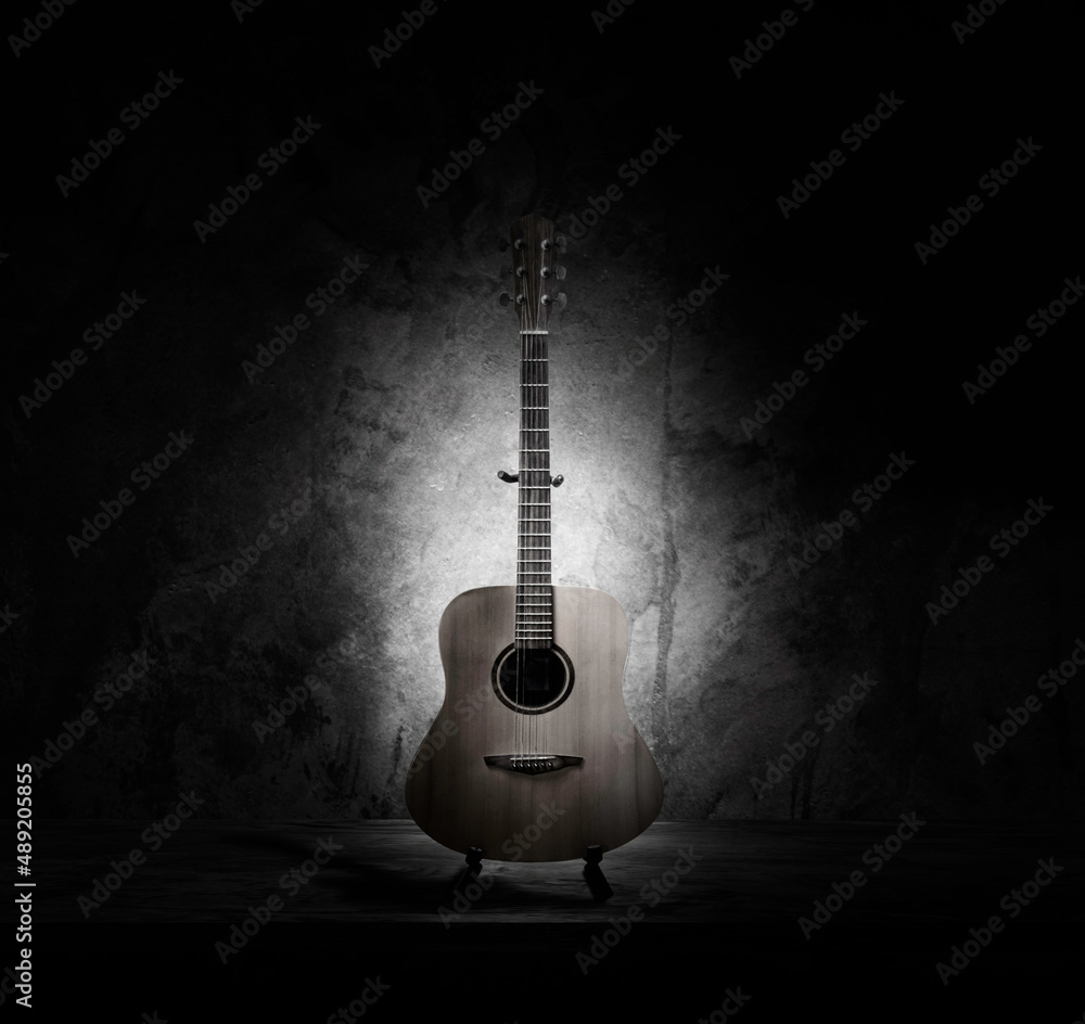 Obraz premium acoustic guitar instrument musical retro style. Material Face Wood Solid Spruce, Mahogany Body. Art photography. Isolated on wall cement background.