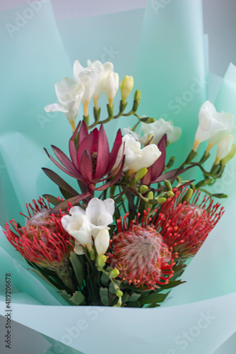 exotic bouquet of flowers. Leukadendron red and leukospermum, freesia photo